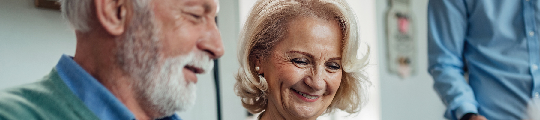 Smiling senior couple enjoying a conversation together in a warm and friendly setting.